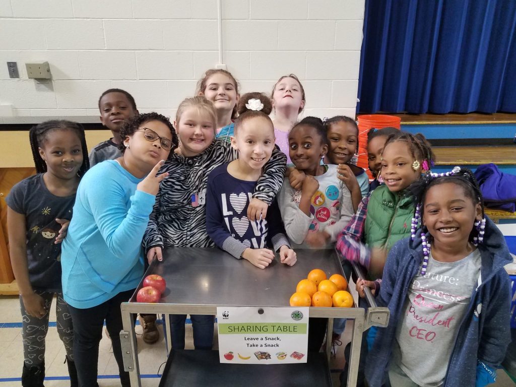 An elementary school class around a share table.