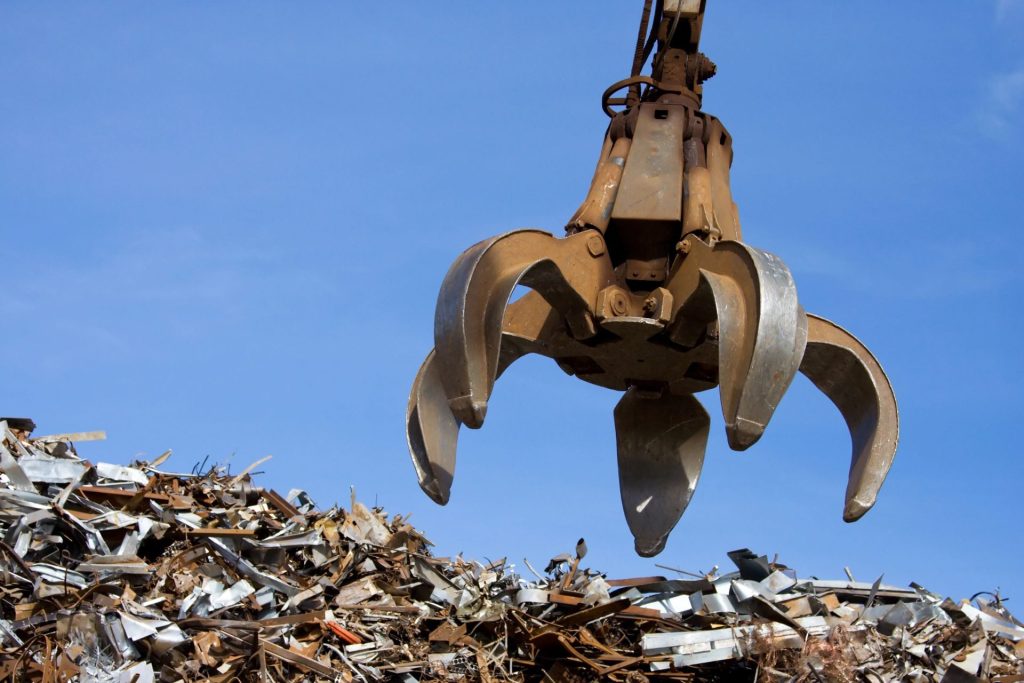 A claw outstretched over metal scrap