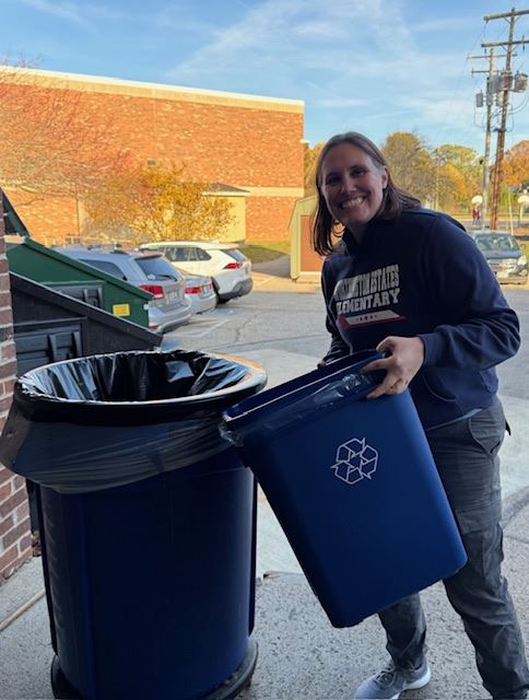 A teacher recycling at Worthington Estates Elementary School.