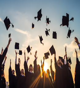 High school graduates throwing their caps