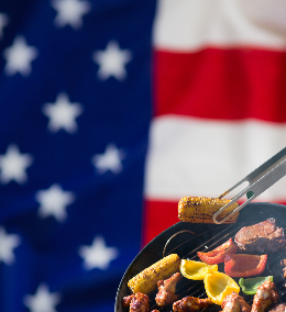 A barbecue with an American flag in the background.