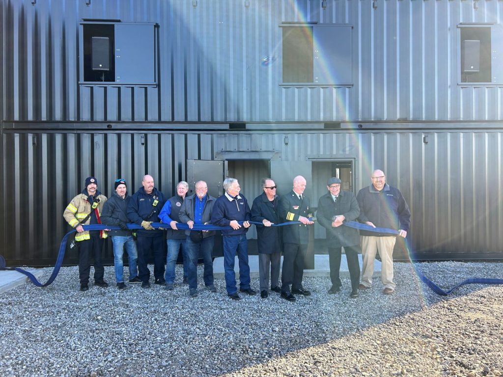 Firefighters holding a fire hose