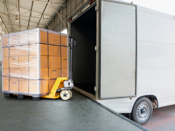 A shipment being loaded into a shipping container