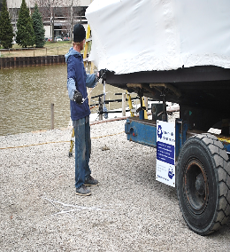 A man shrink-wrapping a boat