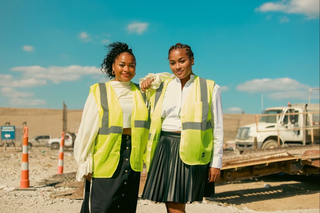 Two women in front of a landfill.